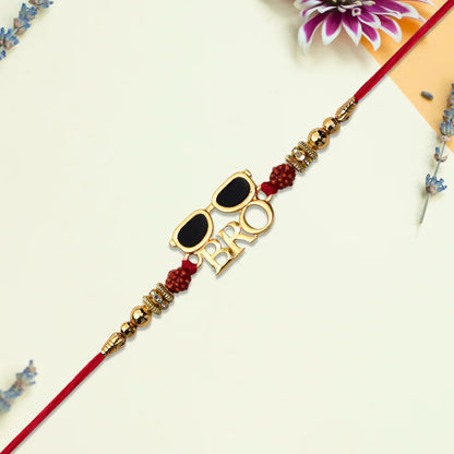 Decorative bracelet with sunglasses and 'BRO' letters on a light background