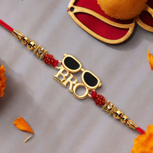 Decorative bracelet with 'BRO' and sunglasses design on a gray background with marigold flowers.