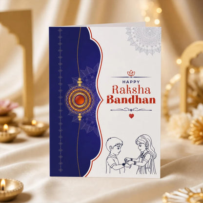A greeting card for Raksha Bandhan, featuring a navy blue and white design with a decorative mandala and line art of a boy and girl exchanging a necklace. The card is displayed on a draped cream fabric with warm bokeh lights in the background.