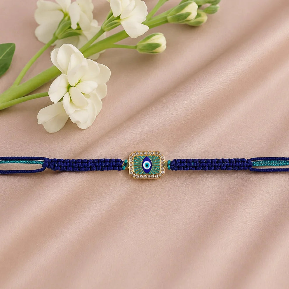 Navy blue bracelet with a decorative clasp on a beige fabric background with white flowers.