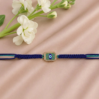 Navy blue bracelet with a decorative clasp on a beige fabric background with white flowers.